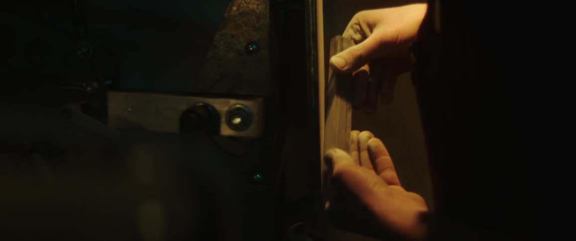 A person is sharpening a blade on a machine