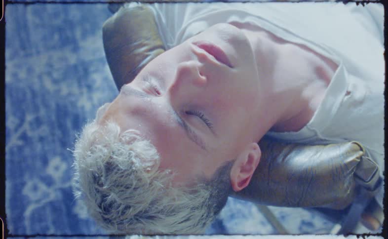 A man sitting in a chair falling asleep