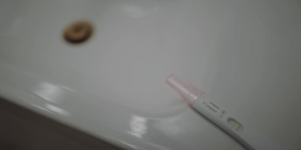 A pregnancy test is on the sink