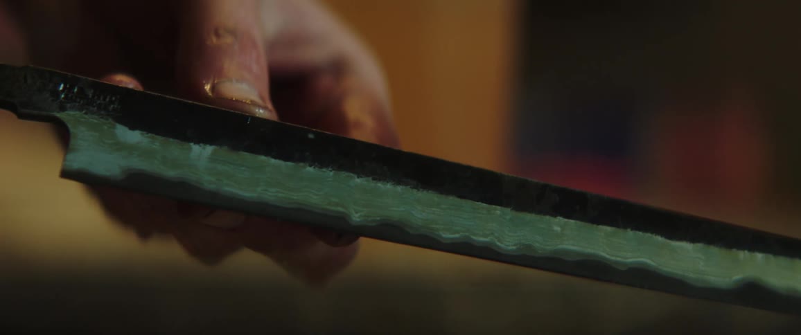A person has wet a metal blade
