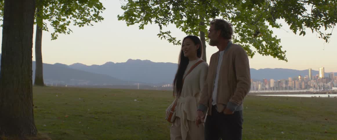 A couple walk in the park holding hands