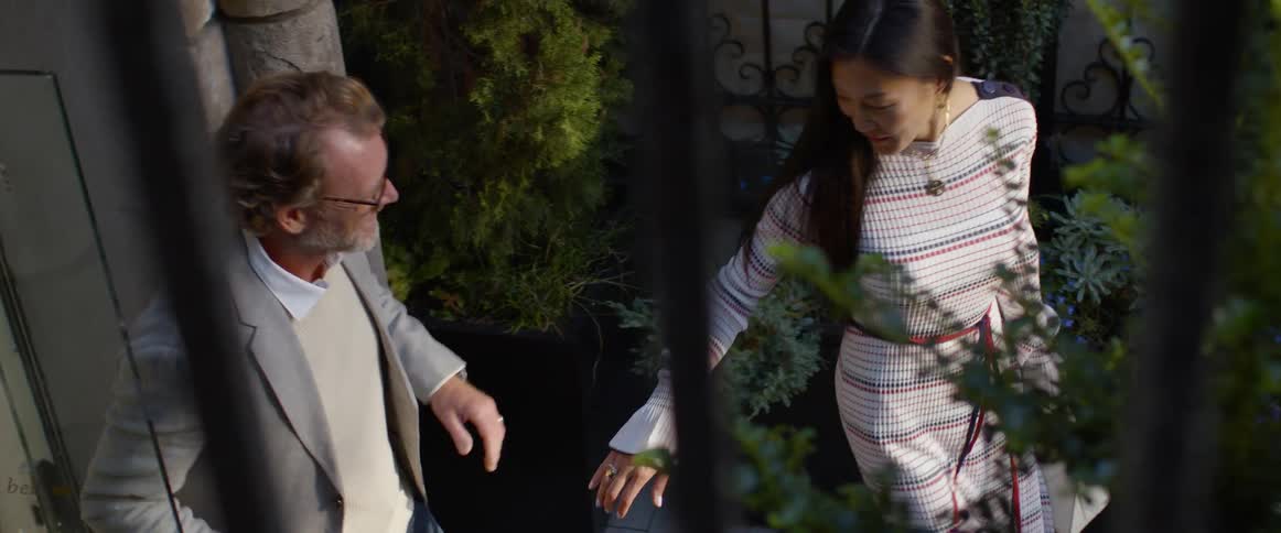 Two people that are walking out a door to go outside