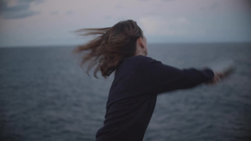 Woman scatering the ashes of a loved one on the ocean