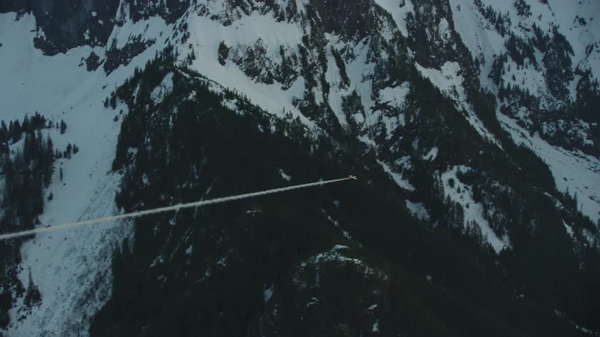 A single engine piston aircraft flies with smoke straight and level before steeply climbing straight up in the sky