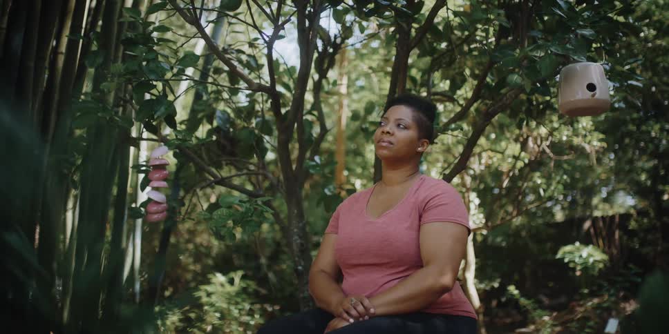 A portrait of a woman sitting outside