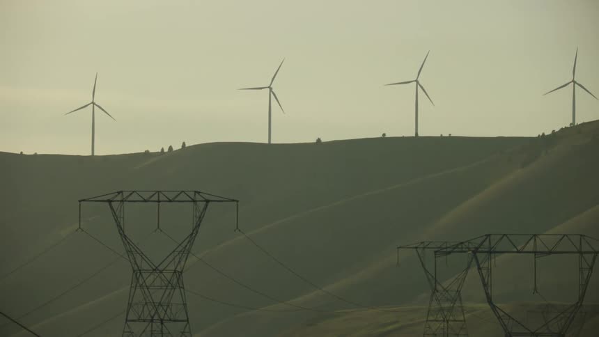 Renewable energy and energy transmission are seen at the same time in this electrical grid energy distribution shot