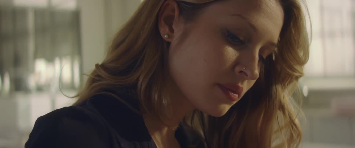 A woman is looking down at something at home