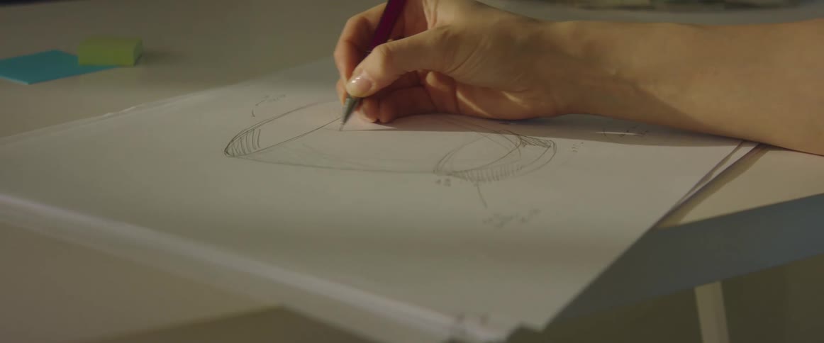 A woman in an office makes sketches