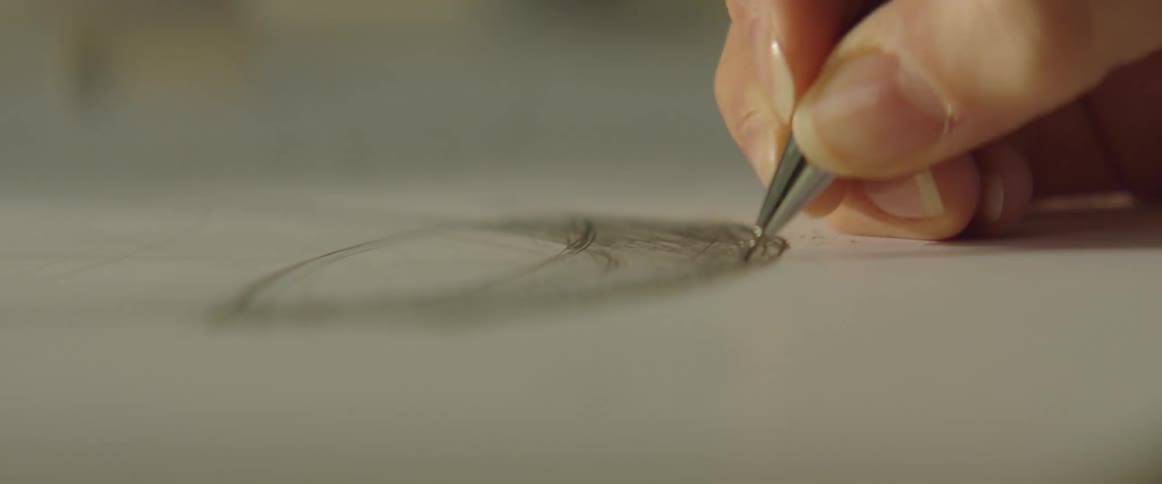 A person sketching on a piece of paper