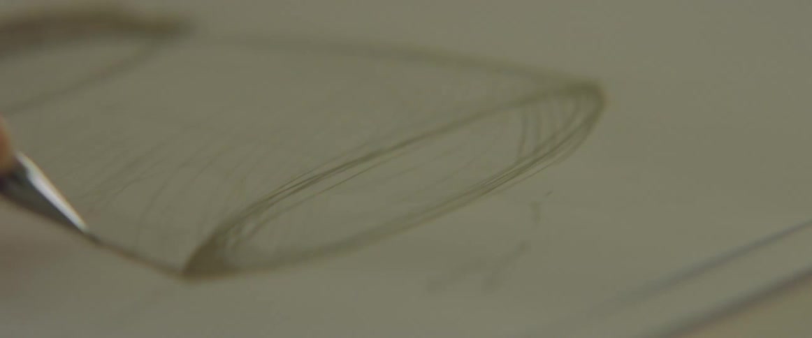 An artist sketching on a piece of paper