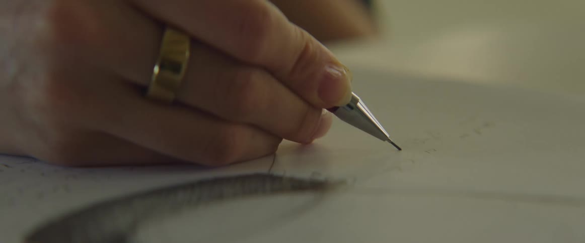 A person handwritting with a mechanical pencil on paper