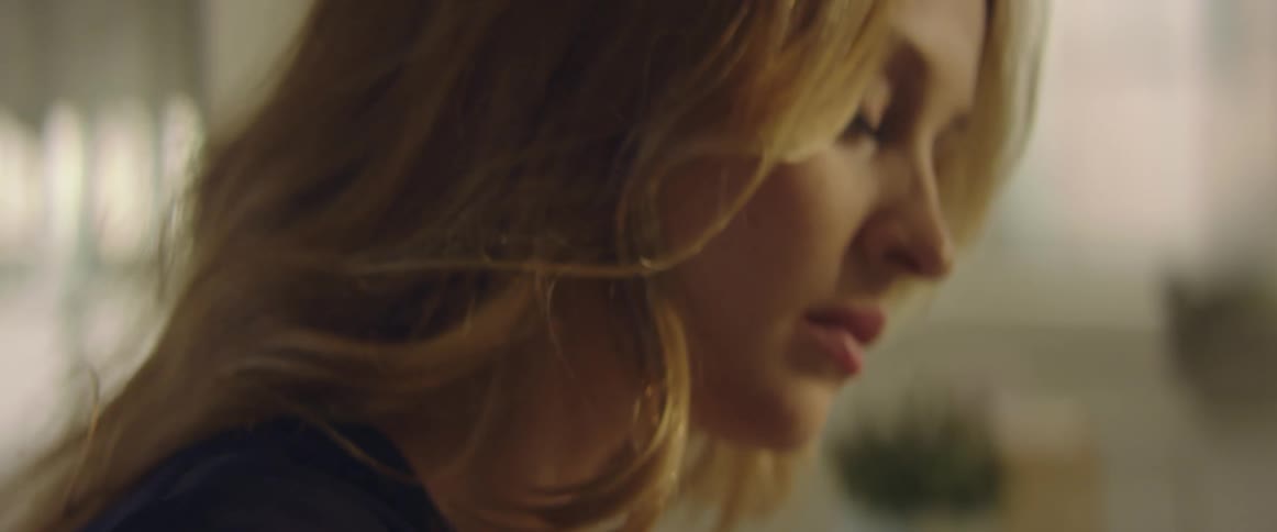 Long haired blonde woman face inside a room