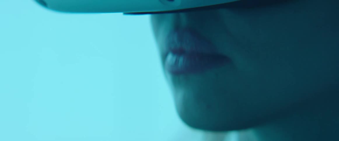 Close up of a woman testing virtual reality goggles inside an office