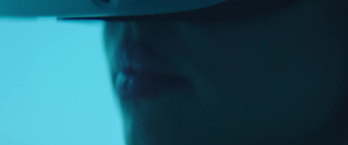 A woman in a room with a virtual reality headset with a wall in the background