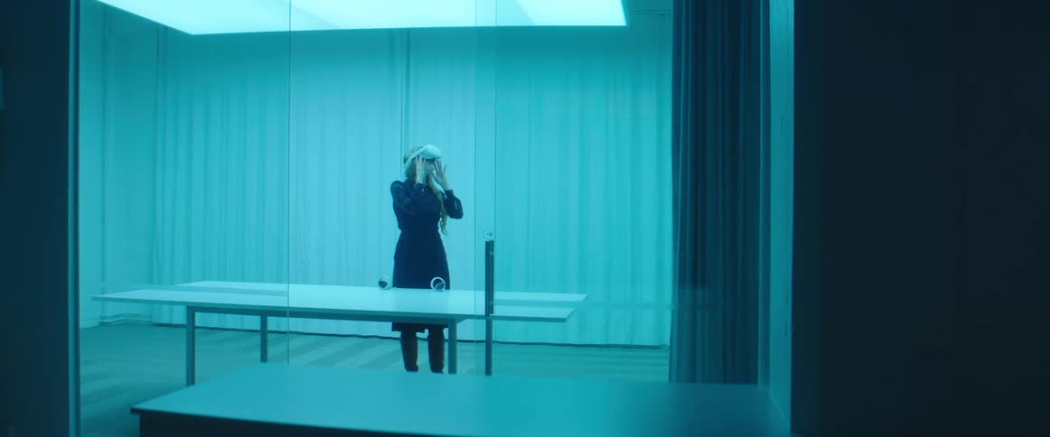 Woman testing virtual reality goggles in an office