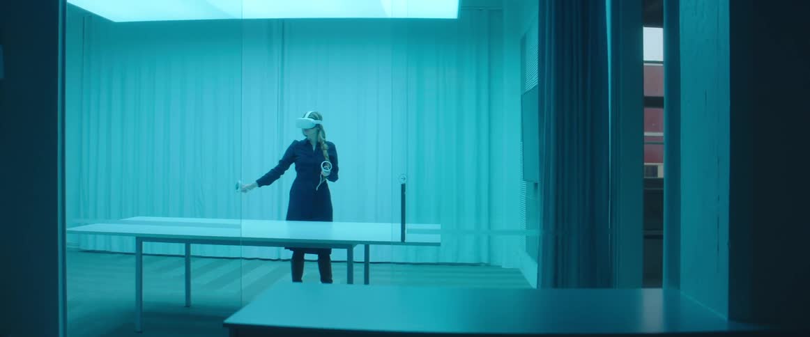 A woman moves her arm around as she plays a virtual reality game