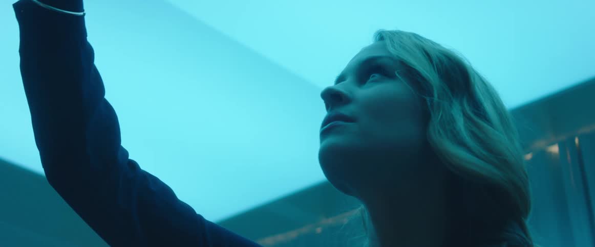 A woman is using a writing instrument in the air