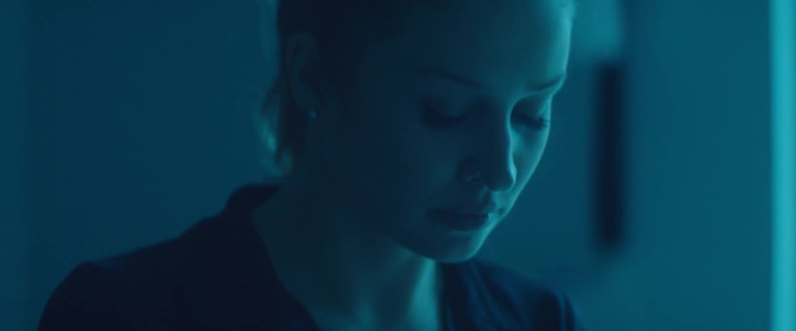 A woman looking around a room with a pensive look on her face