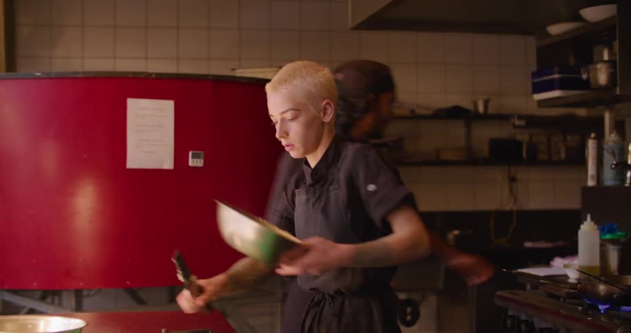 Chef cutting vegetables with a knife on a restaurant kitchen