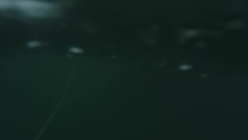 Waves rolling around a boat with a man on it