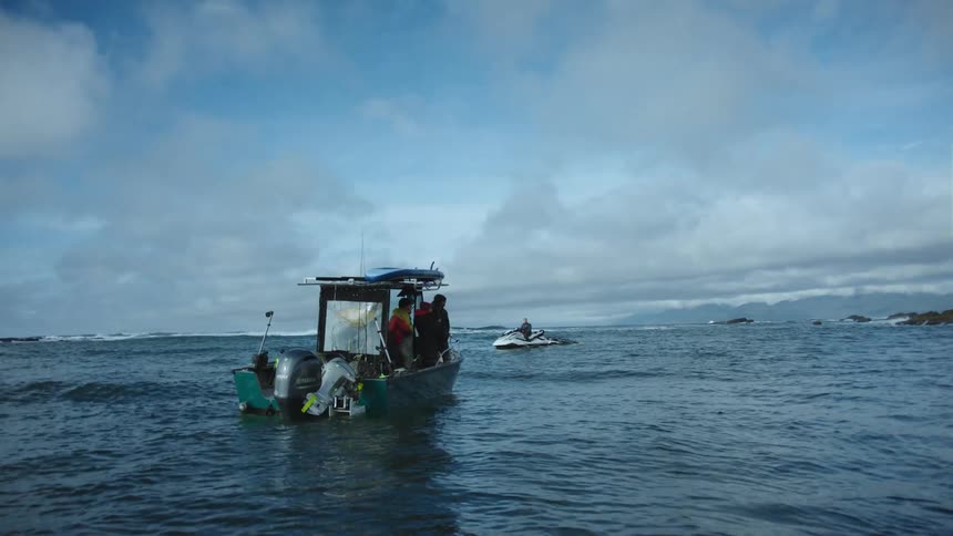 People are on a boat over the ocean during the day