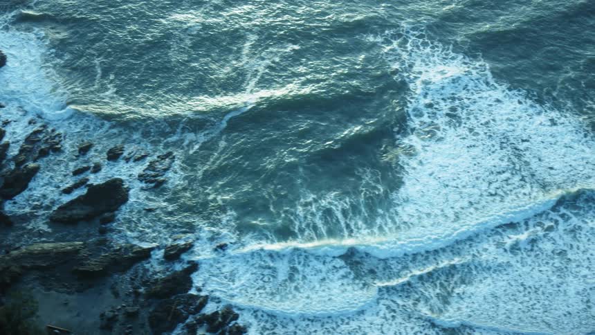 The waves move against the shore below