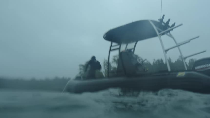 A person fishing off of a small boat