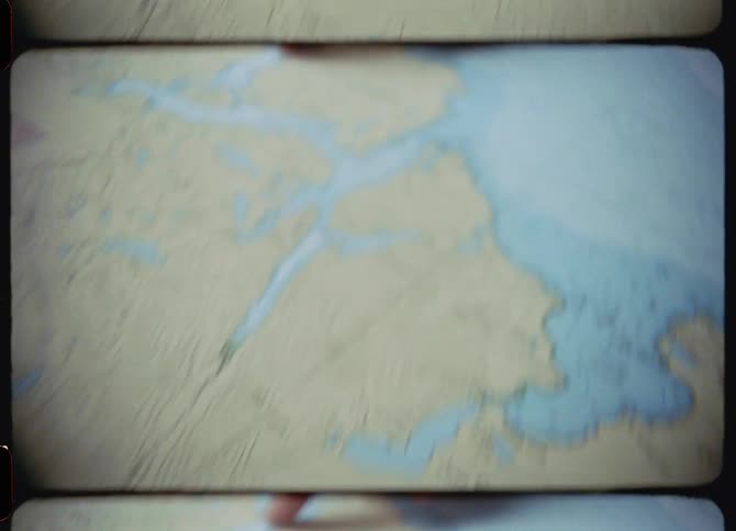 A finger pointing and moving across the surface of a map