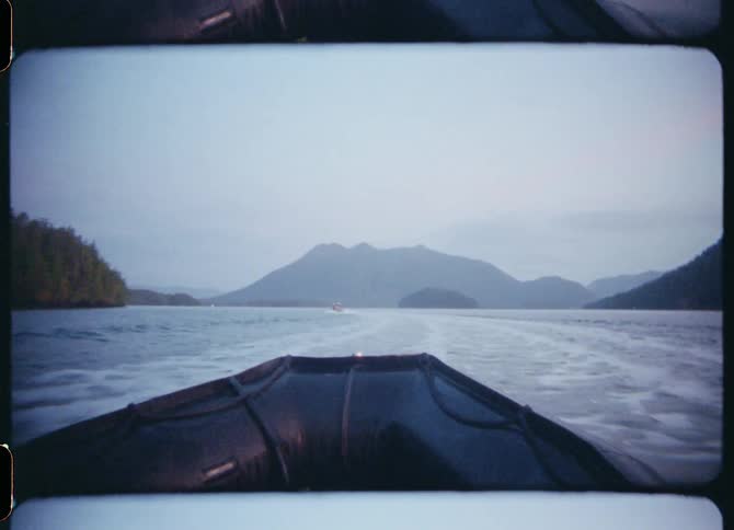 Boat navigating on a lake in the mountains in the morning