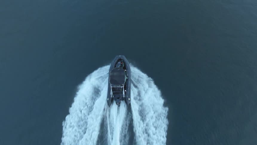 Aerial view of a boat navigating on the surface of a lake