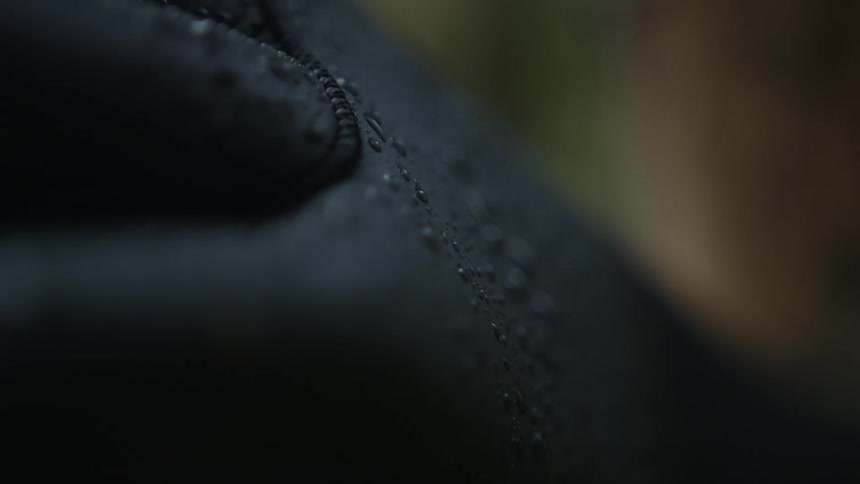Black green and brown colors that look like water droplets on a jacket