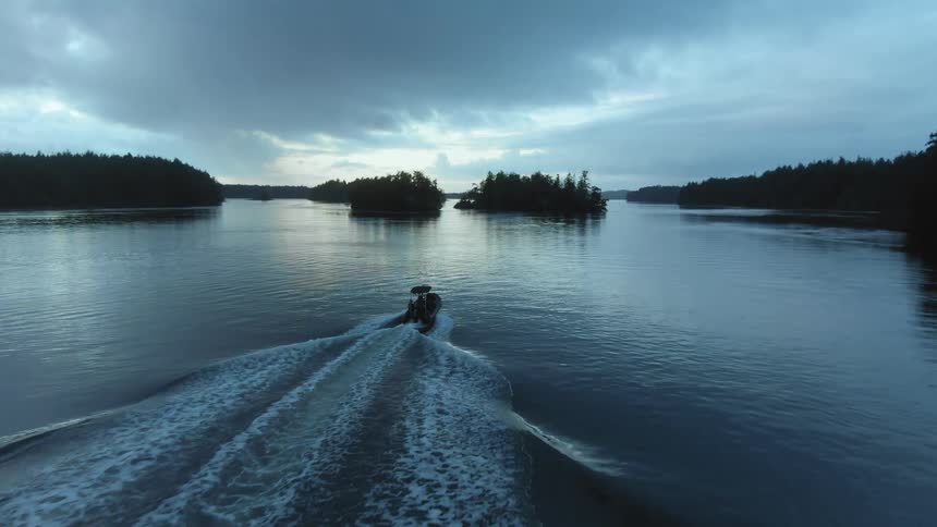 A boat is riding towards the islands ahead