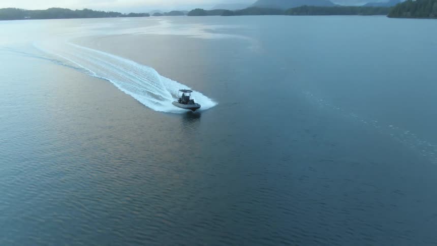 Yacht navigating on the surface of a lake at sunset