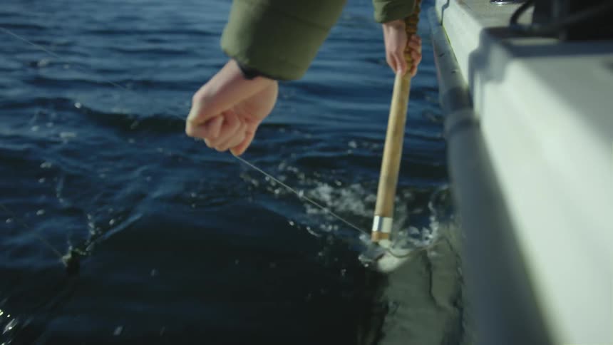 A person is pulling in a fish he has on the line