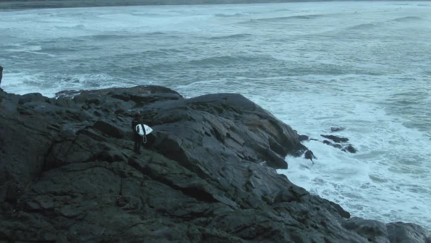 A view of waves crashing against rocks at the coast