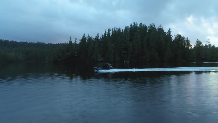 A boat speeds in the lake water