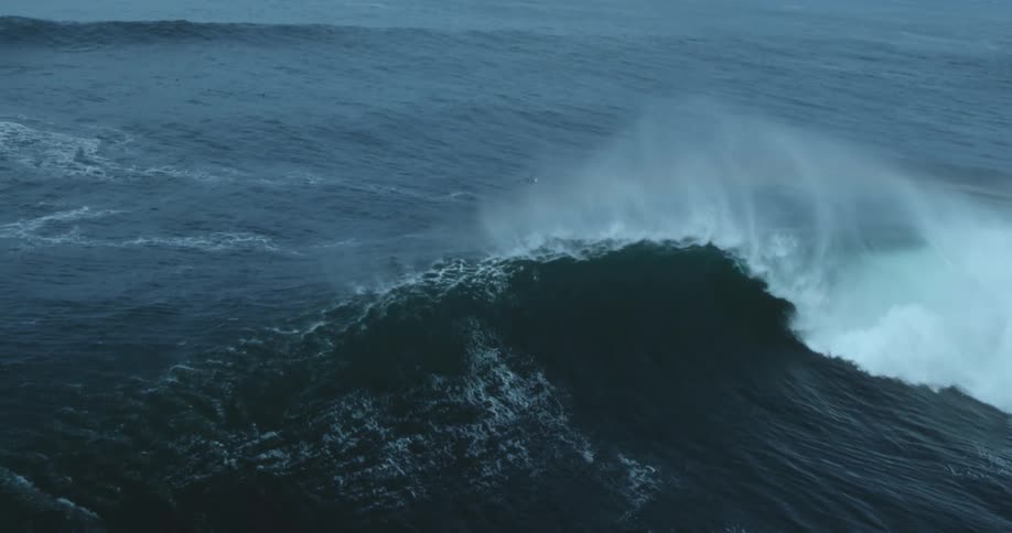 Huge wave rolls in splashing on rough water