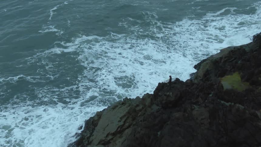 An aerial view of the ocean at cliffs