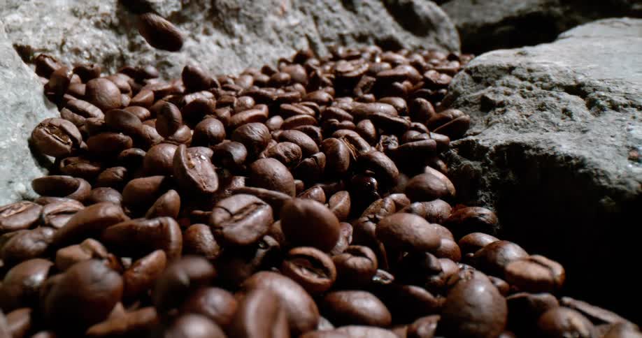 A view of coffee beans dropping onto rocks