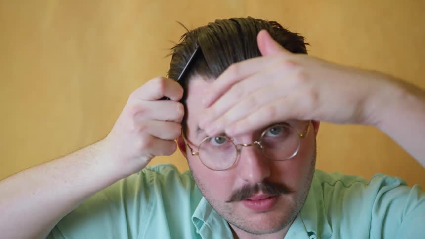 A man combing back his hair