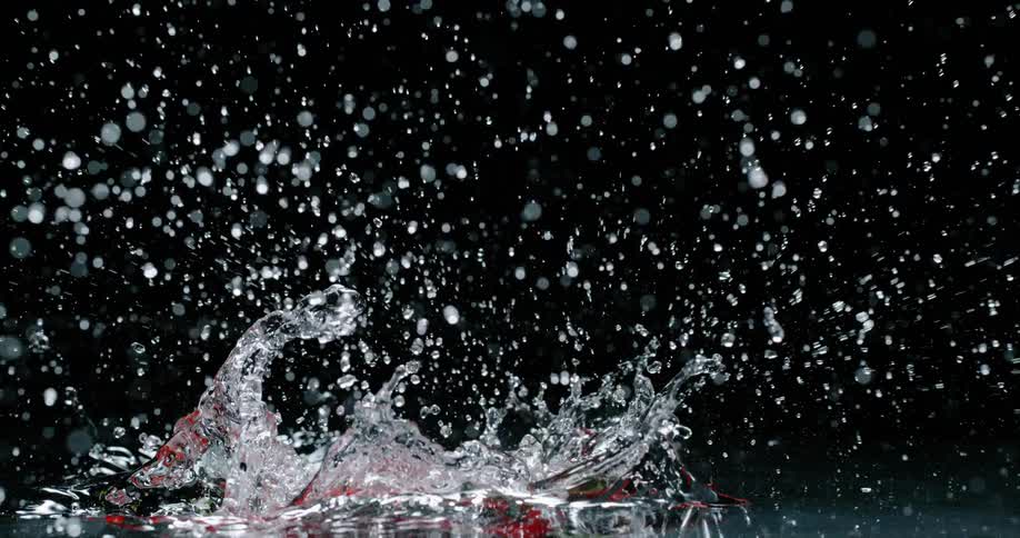 A view of peppers falling into water in slow motion