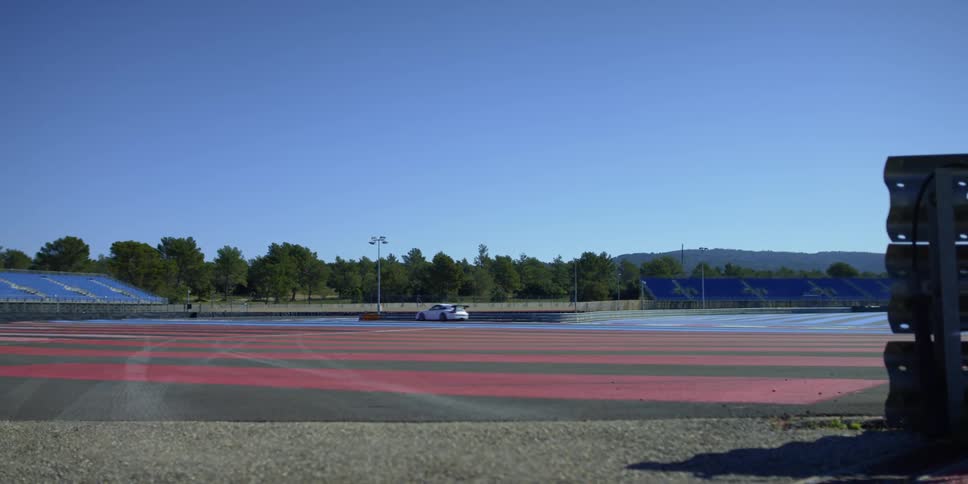 Sports car driving on a stadium at morning