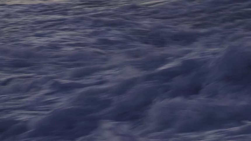 The heavy waves crash around in the sea