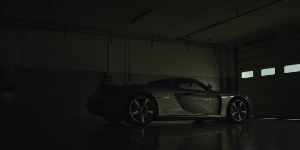 A car is parked in a dark garage