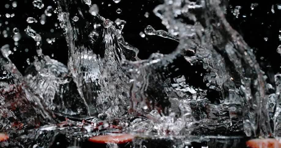 A view of strawberries dropping into water