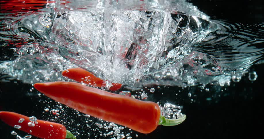 Peppers falling in to water for a photo shoot
