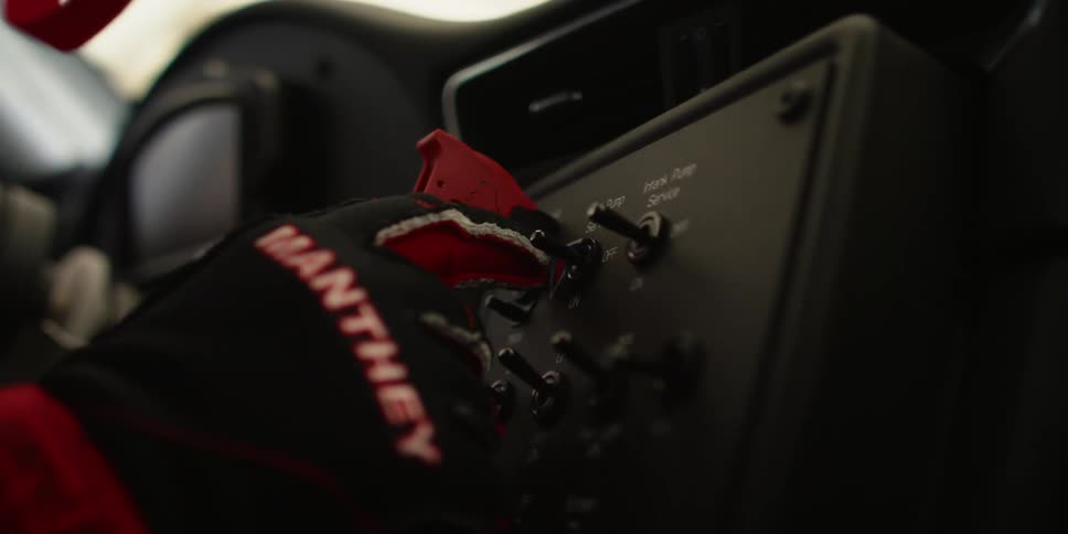 A person turning on a switch in a car