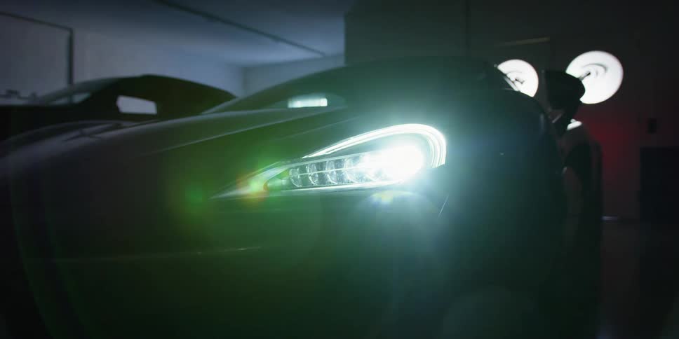 A car with headlights in a garage