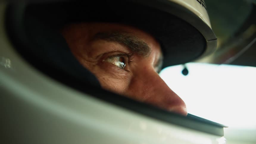 A man wearing a helmet in a car