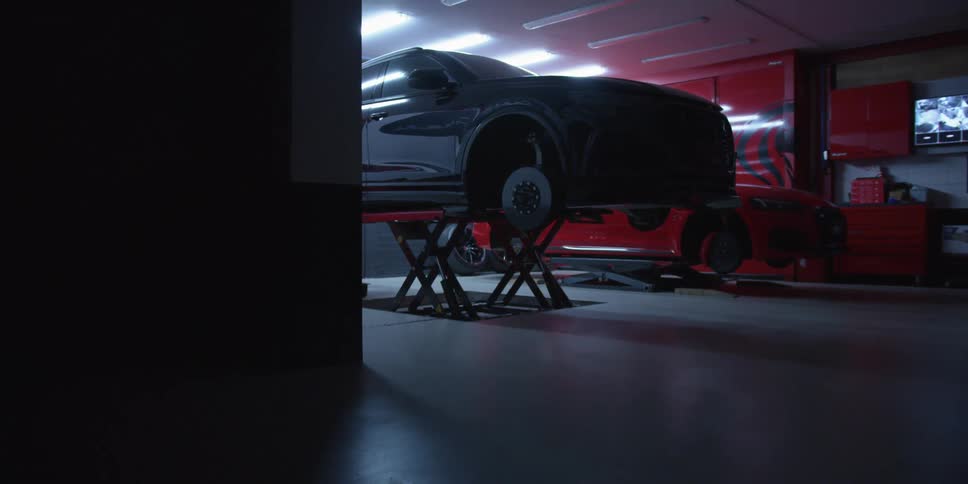 A car on a hoist in a garage